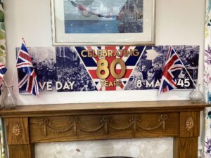 VE Day poster above the fireplace.