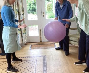 Staff member and residents enjoying a ball game.