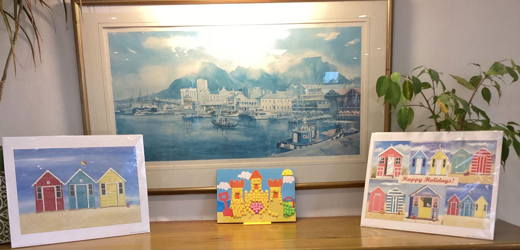 Seaside themed pictures on display and a mosaic picture made by a resident.