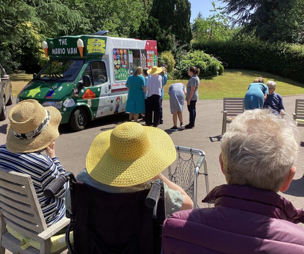 Residents and staff enjoying ice creams together.