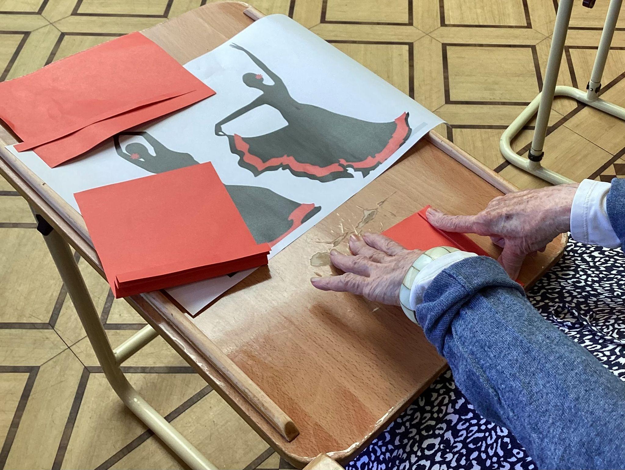 A resident creating a fan for the dancer's skirt