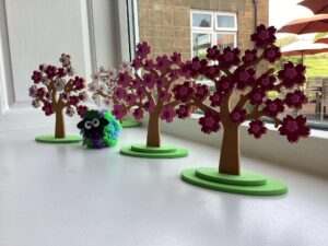 A sheep and blossom trees created by residents.